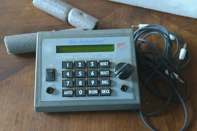A device with a number pad, dials, and a small read out.